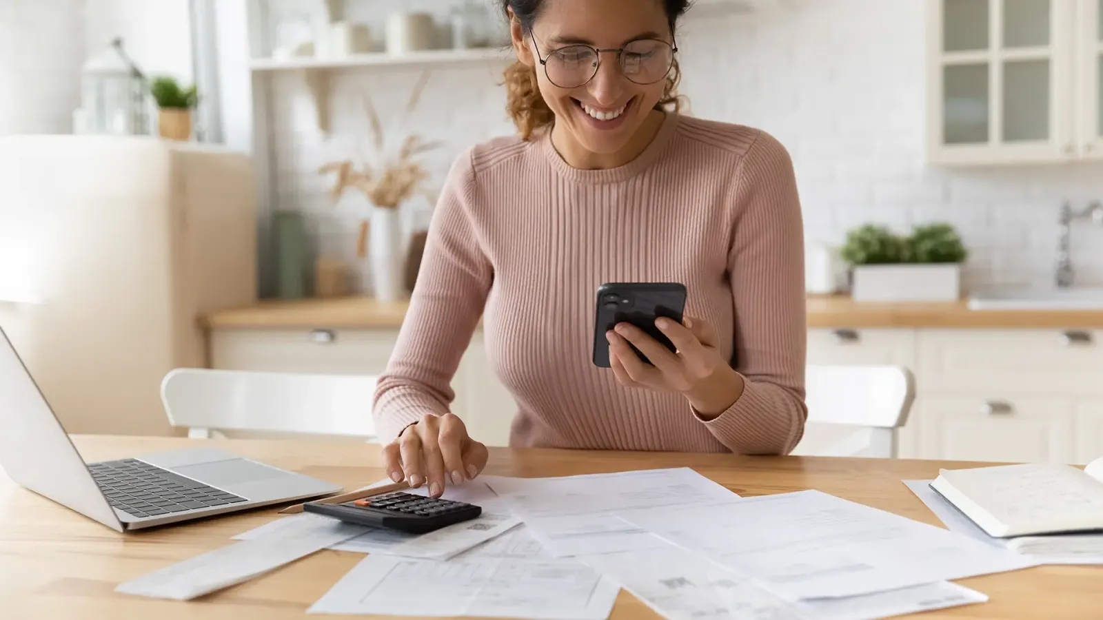 woman with phone and laptop